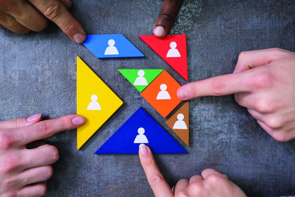 Person's hands completing puzzle