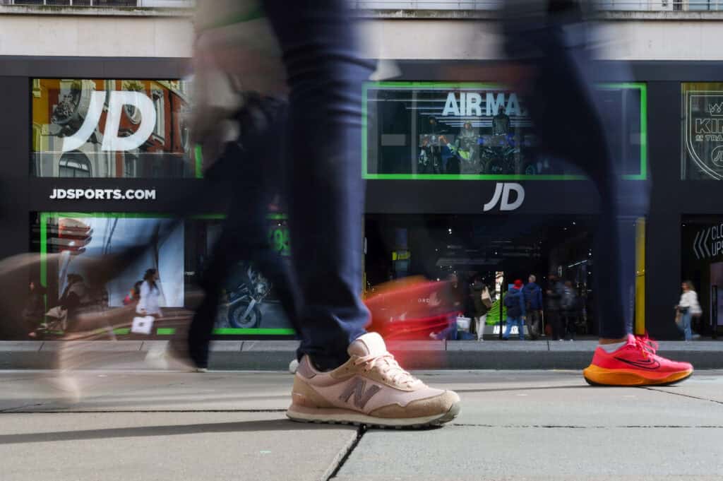 Shoppers pass a JD Sports store in London.
