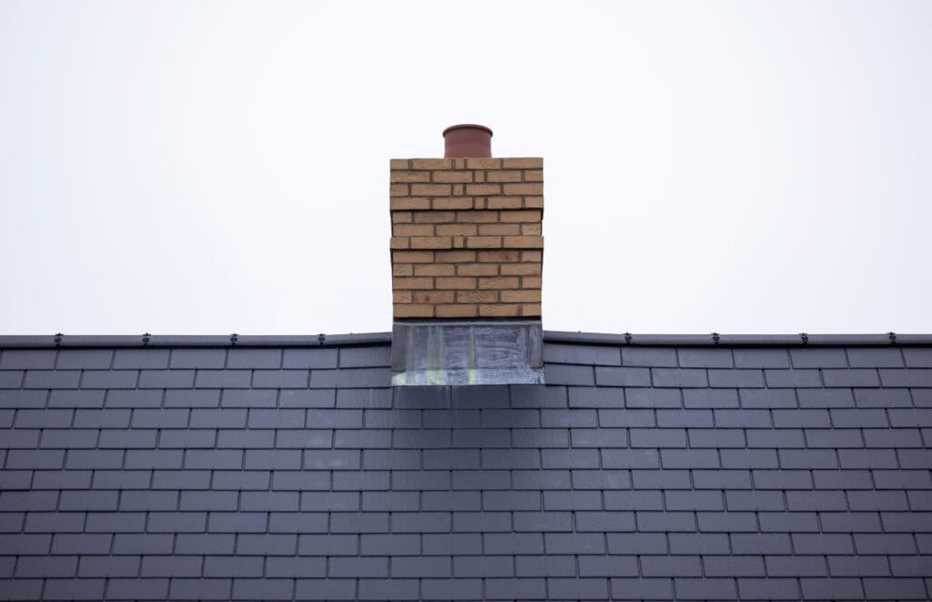 The chimney stack and roof tiles of a new home.