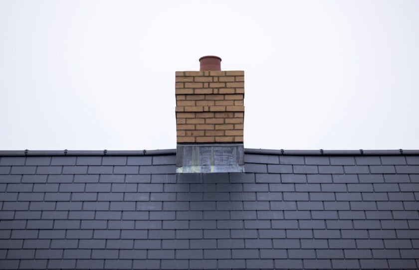 The chimney stack and roof tiles of a new home.