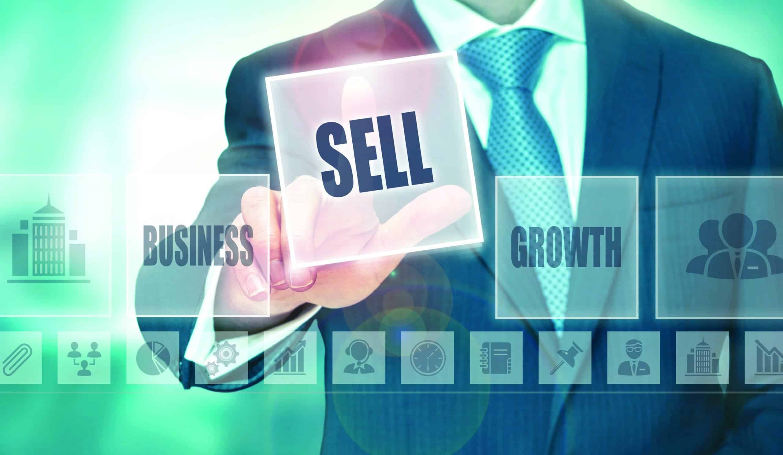 A businessman pressing a sell button on a transparent screen.