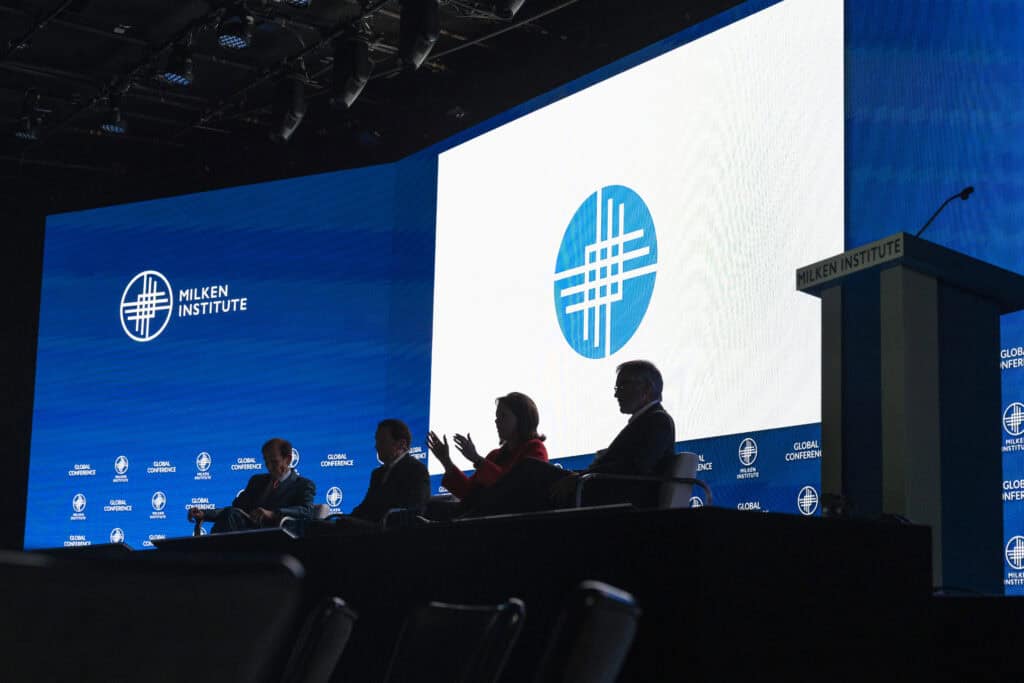 Speakers participate in a panel discussion during the Milken Institute 