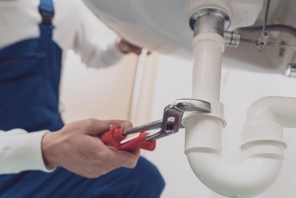 Plumber fixing sink