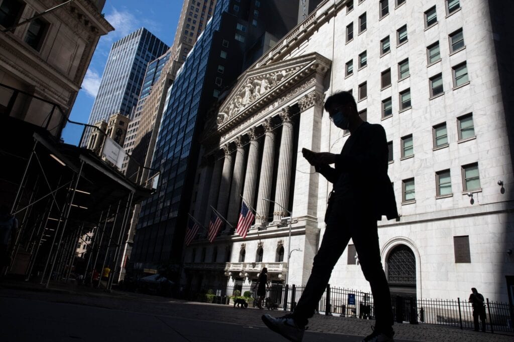 Pedestrian passing in front of the New York Stock Exchange in New York