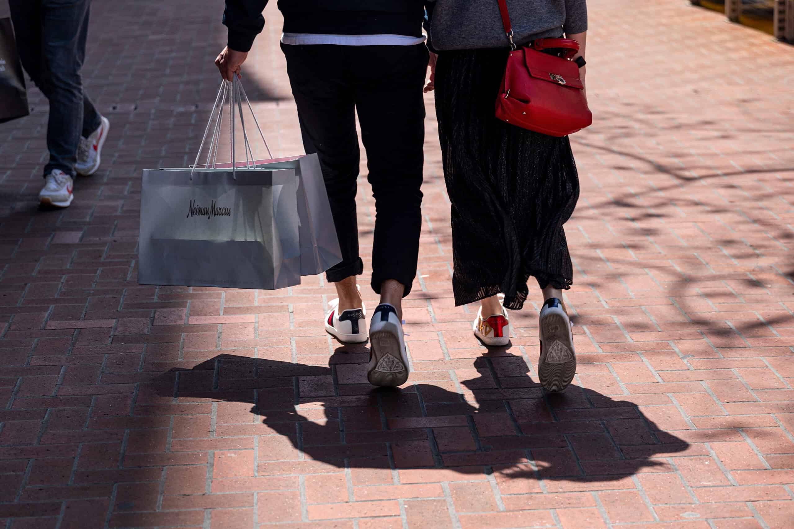 Shoppers carry Neiman Marcus branded bags