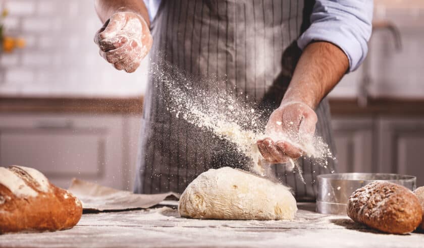 A baker kneading dough