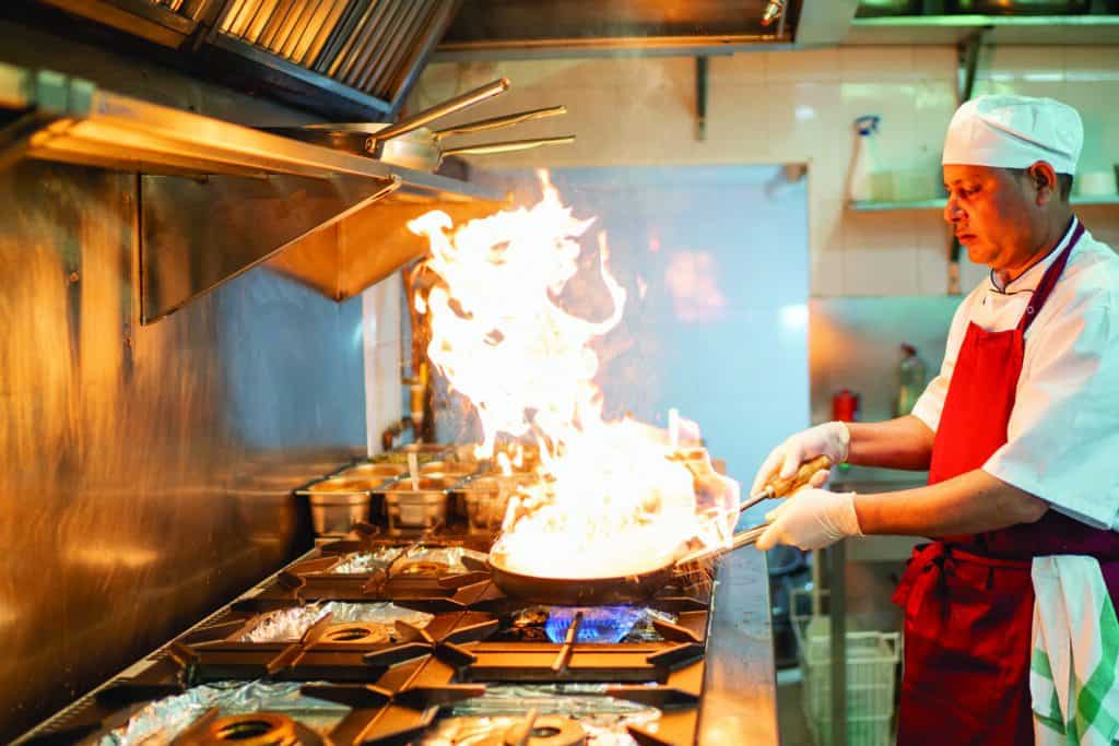chef cooking in industrial kitchen