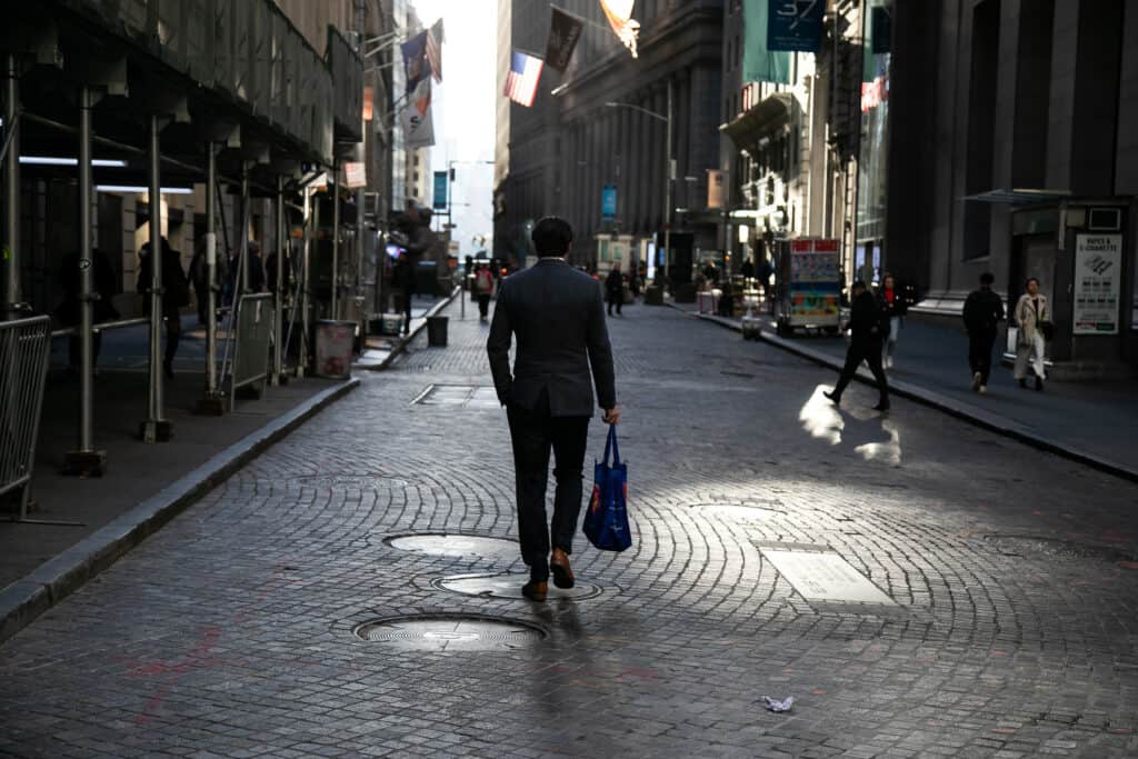 A pedestrian on Wall Street near the New York Stock Exchange