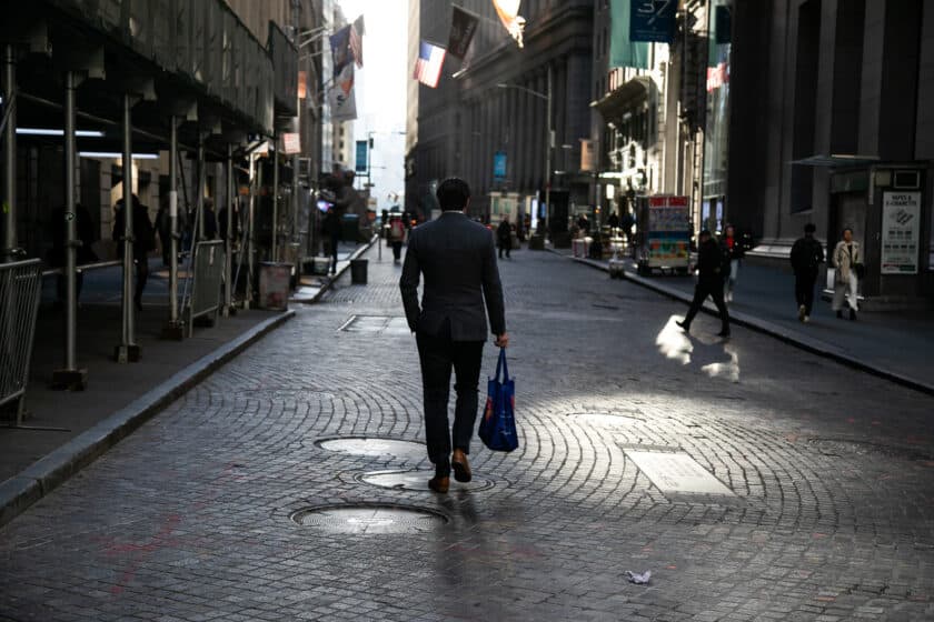 A pedestrian on Wall Street near the New York Stock Exchange