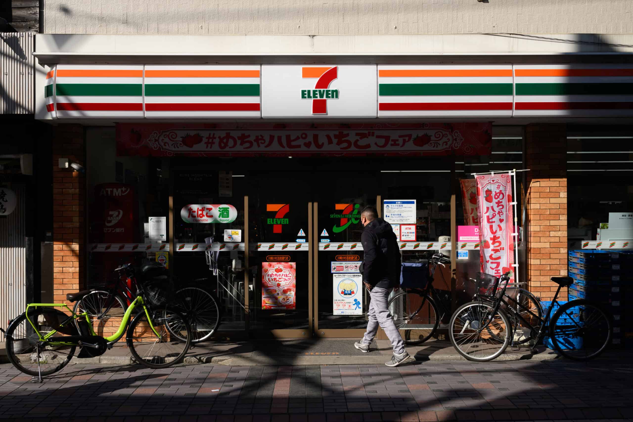 A customer enters a 7-eleven convenience store