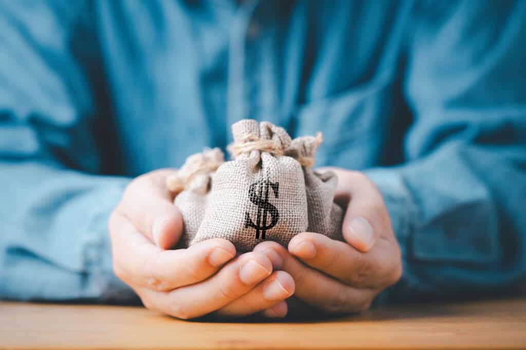 Businessman holding money bag