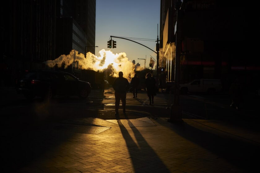 Pedestrians cross a street near the NYSE